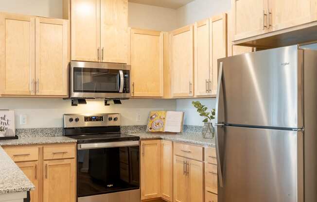 a kitchen with stainless steel appliances and wooden cabinets