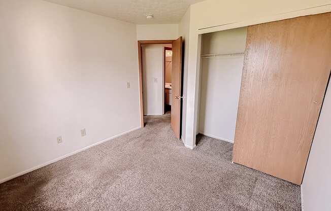 an empty living room with white walls and doors