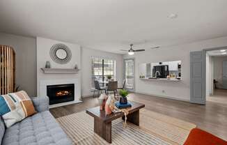 A modern living room with a fireplace and a grey sofa.