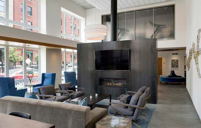 A modern living room with a fireplace and a television.