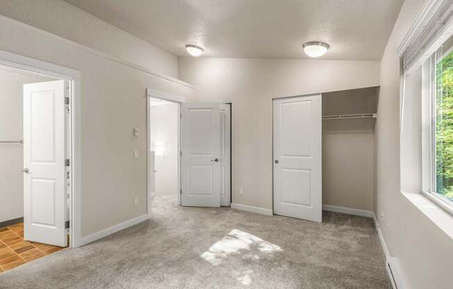 A room with white doors and a carpeted floor.