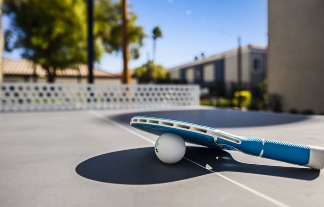 a blue and white airplane sitting on top of a tennis court