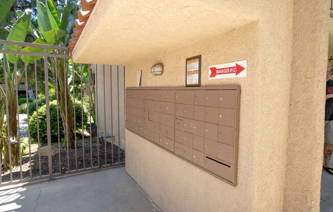 a garage door with a mailbox and a sign on the side