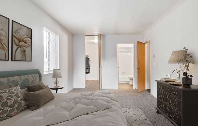 A bedroom with a large bed and a dresser.