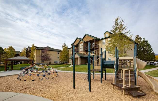 A playground with a slide and a climbing frame.
