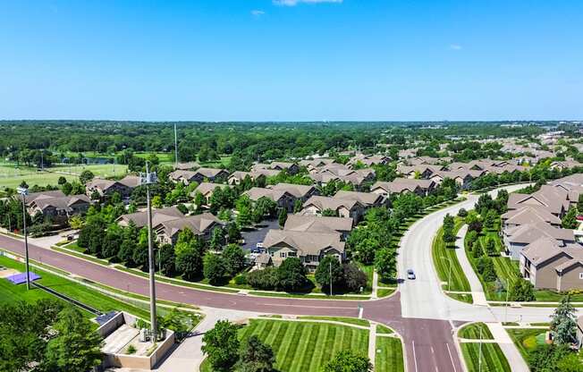 A suburban neighborhood with houses and a road.