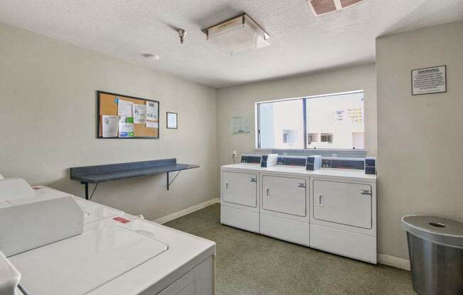 a washer and dryer are in a room with a window  at Masselin Park West, Los Angeles, 90036