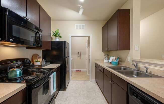 a kitchen with a stove and a sink and a refrigerator