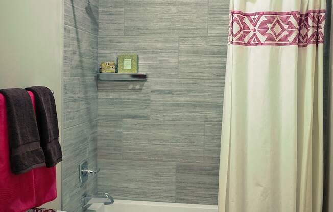 a bathroom with a toilet and a bathtub with a shower curtain
