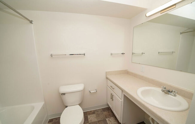 a renovated bathroom with white cabinetry