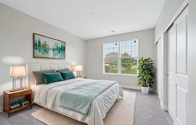 A bedroom with a bed, nightstand, and a painting on the wall.