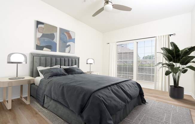 an image of a bedroom with a bed and a ceiling fan