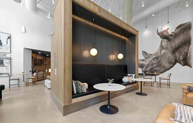 A modern living room with a large wolf head on the wall.