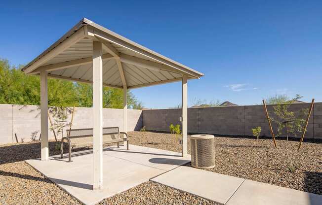a pavilion with a bench and a trash can at Grandstone at Sunrise, Peoria, AZ