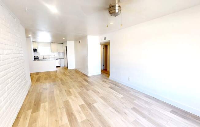 A room with wooden floors and white walls.