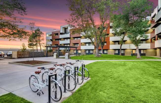 a row of bikes parked in front of a building