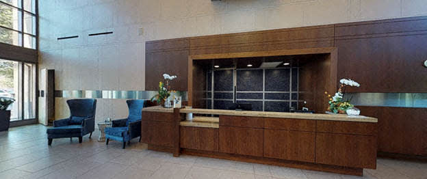 a lobby with a reception desk and chairs at The Millennium, Virginia