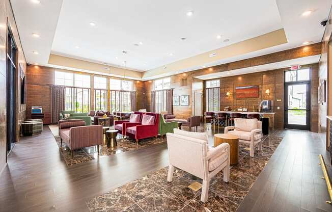 a lobby of a hotel with couches and chairs and a bar