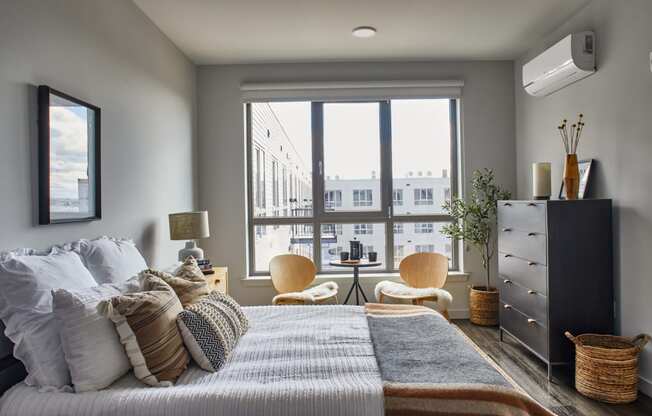 Bedroom with a bed and a large window at Sono Central Residential, Norwalk, CT