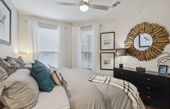 spacious bedroom with two windows and ceiling fan at LynnCora, Texas