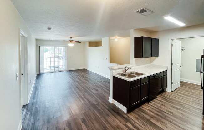 an empty living room and kitchen in an empty apartment