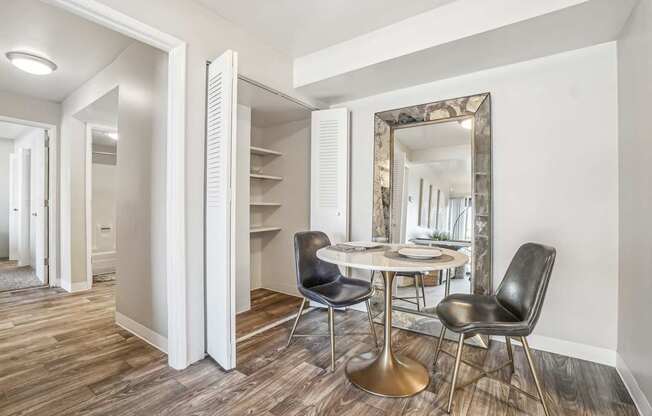 A dining room with a round table and chairs.