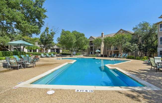 the preserve at ballantyne commons pool and patio with tables and chairs and buildings