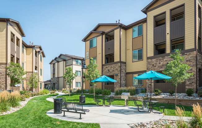 our apartments have a patio with umbrellas and tables
