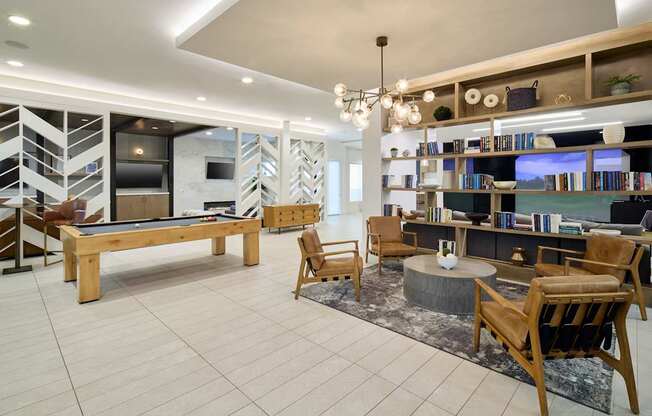 A living room with a pool table and a fireplace.