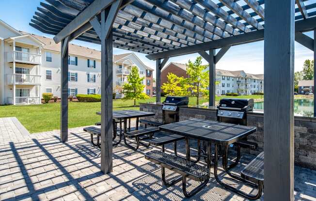 furnished patio with picnic tables and barbecue grill at the preserve at greatstone