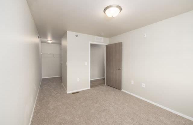 A room with a carpeted floor and a ceiling light.