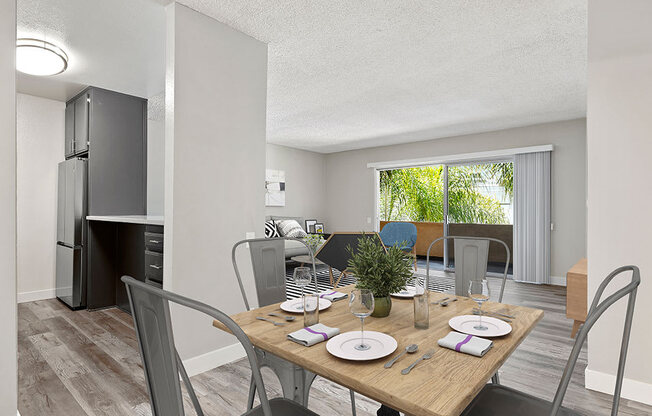 Hardwood floored dining room with view of outdoor patio.