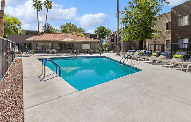 Community Swimming Pool with Pool Furniture at Saddle Ridge Apartments in Tucson, AZ.