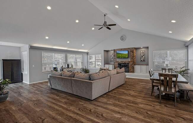 A living room with a couch, a television, and a fireplace.