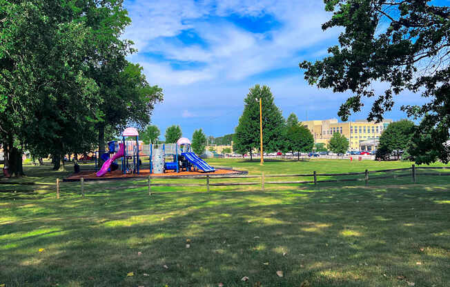 A playground with a slide and a purple slide.