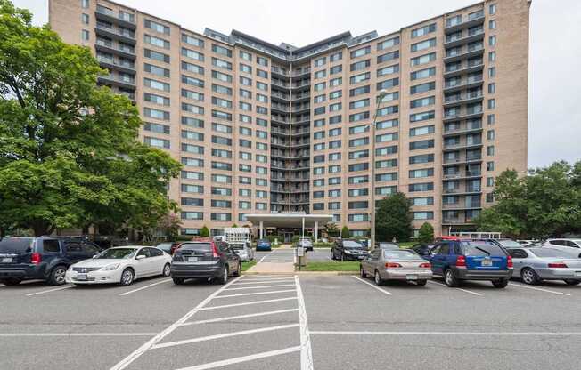 A parking lot in front of a large apartment building.at Sherwood at Southern Towers, Alexandria, VA 22311