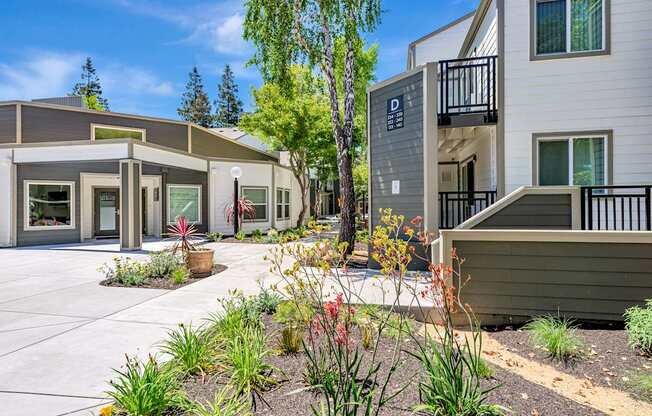 A modern building with a landscaped front yard.