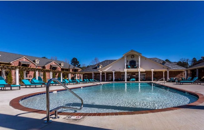 a resort style pool with lounge chairs around it at Arlo Luxury homes Apartments, Arkansas