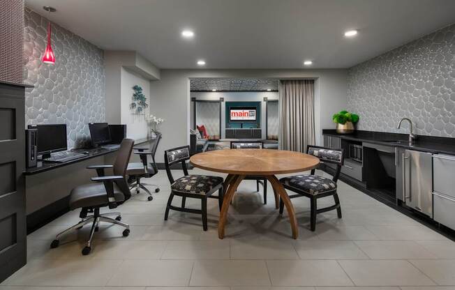 A modern kitchen with a dining table and chairs.