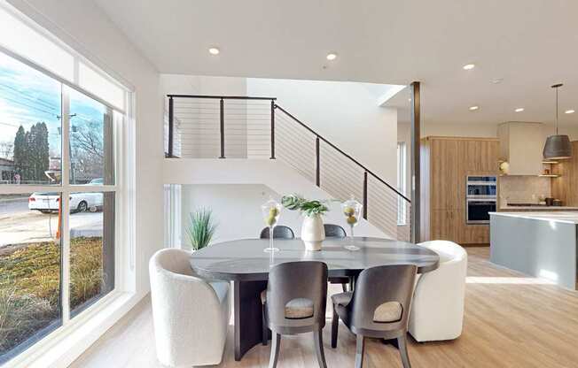 A modern dining room with a glass table and chairs. at One West Drive Apartments, Excelsior, MN 55331