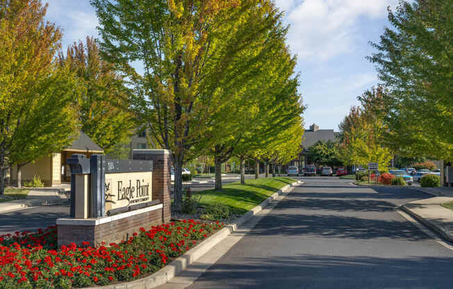 a tree lined street with a sign in front of a building