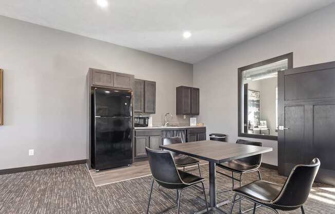 A modern kitchen with a dining table and chairs.