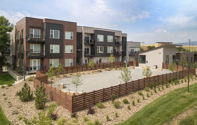 an aerial view of an apartment complex with a large patio and landscaping