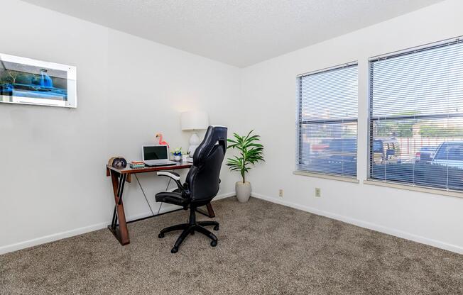 carpeted bedroom with a computer