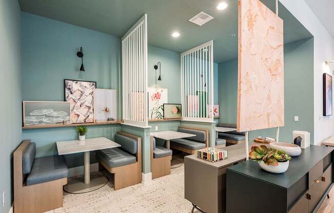 A kitchen with a table and chairs.