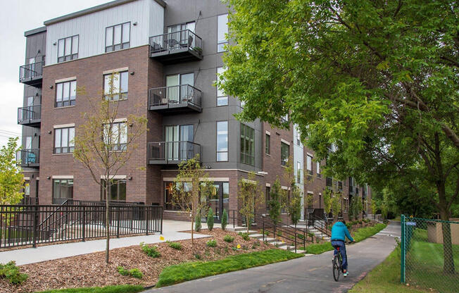 a person riding a bike down a street in front of a building