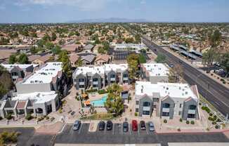 A bird's eye view of a residential area with houses and a swimming pool.