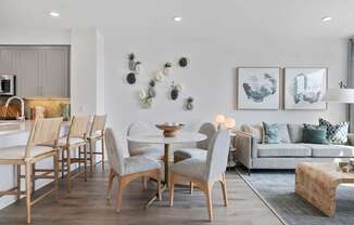 A modern dining room with a wooden table and chairs.