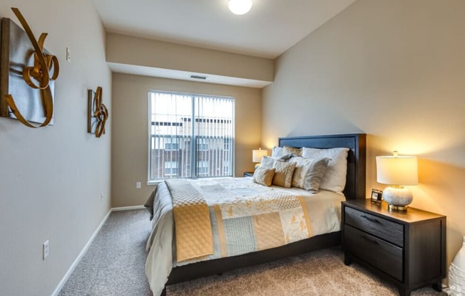 a bedroom with a large bed and a window