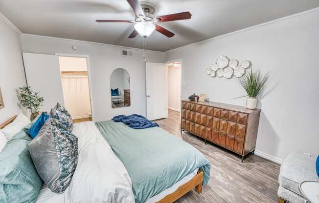 a bedroom with a bed and a ceiling fan